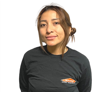 dark haired woman in SERVPRO shirt against white backdrop