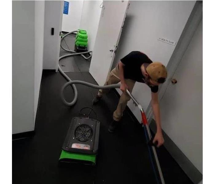SERVPRO team member cleaning commercial water damage
