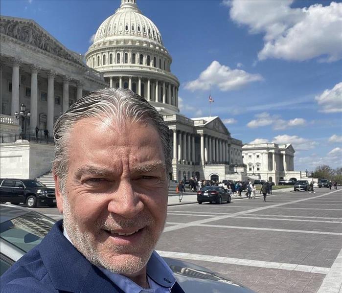 man with gray hair outside Capitol Building